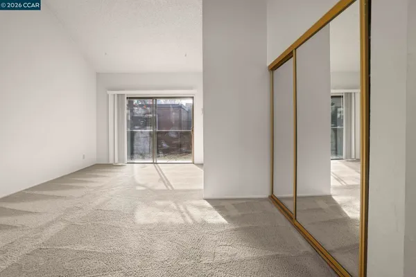 a view of an empty room with glass door