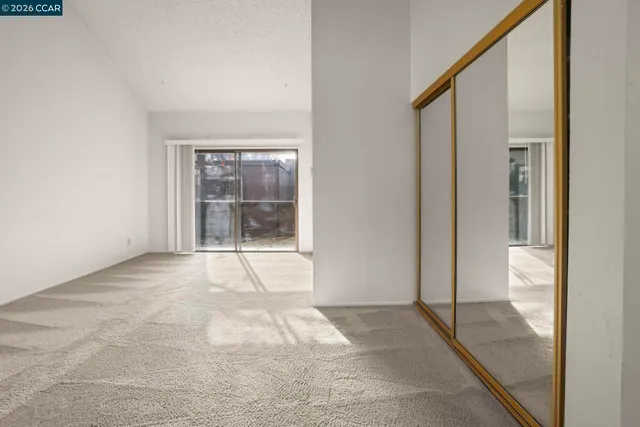 a view of an empty room with glass door