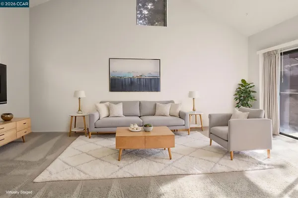 a living room with furniture and a potted plant