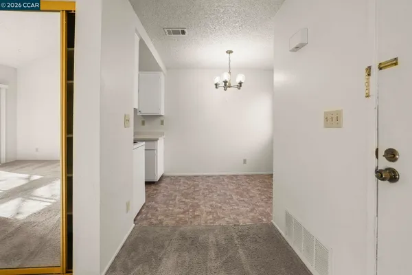 a dining room with furniture and chandelier