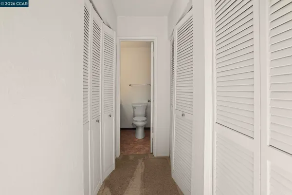 a bathroom with a sink a toilet a mirror and vanity