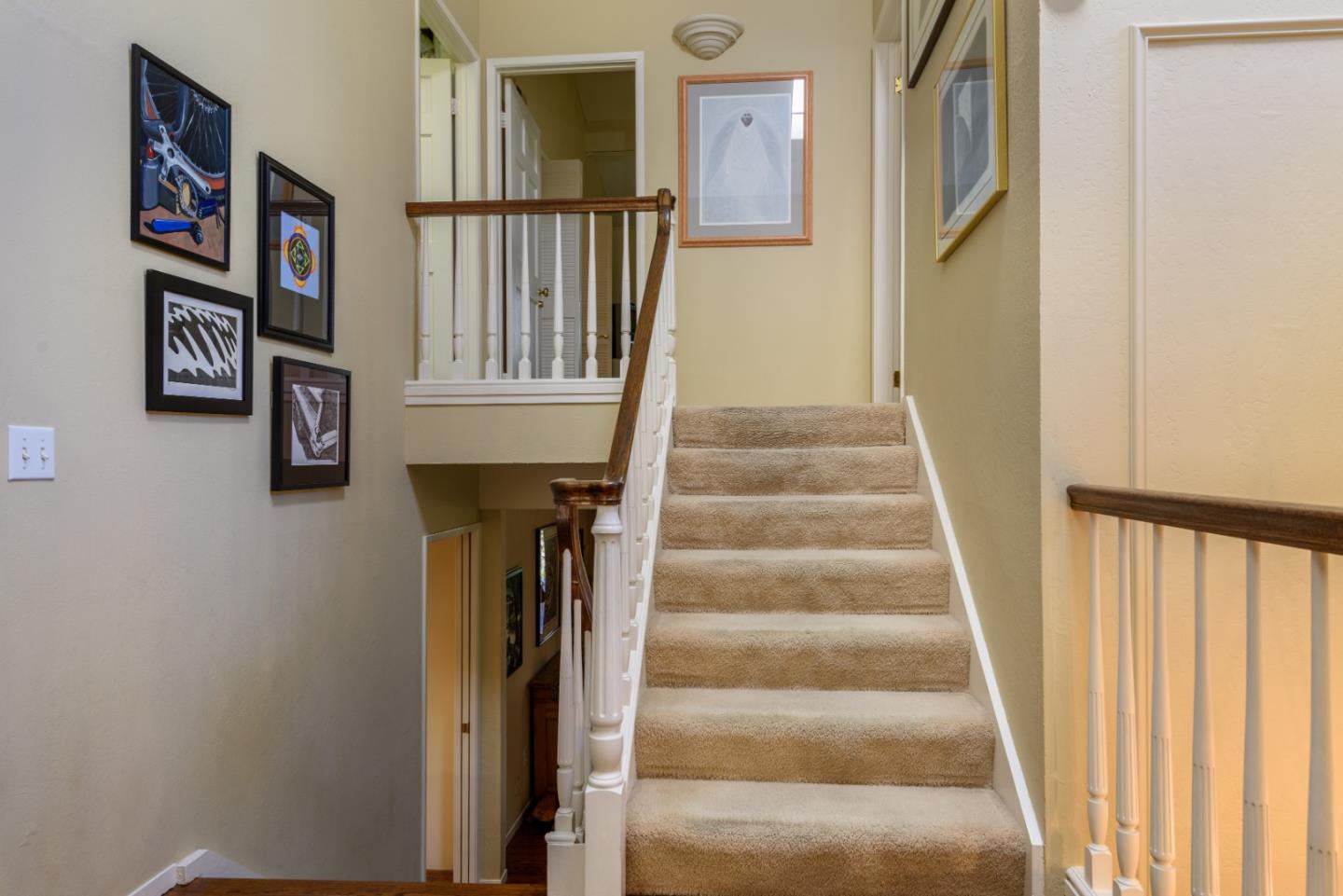 420 Sand Hill Circle Menlo Park, CA 94025 - Photo 29 of 29 a view of staircase with lots of frames on wall and a window