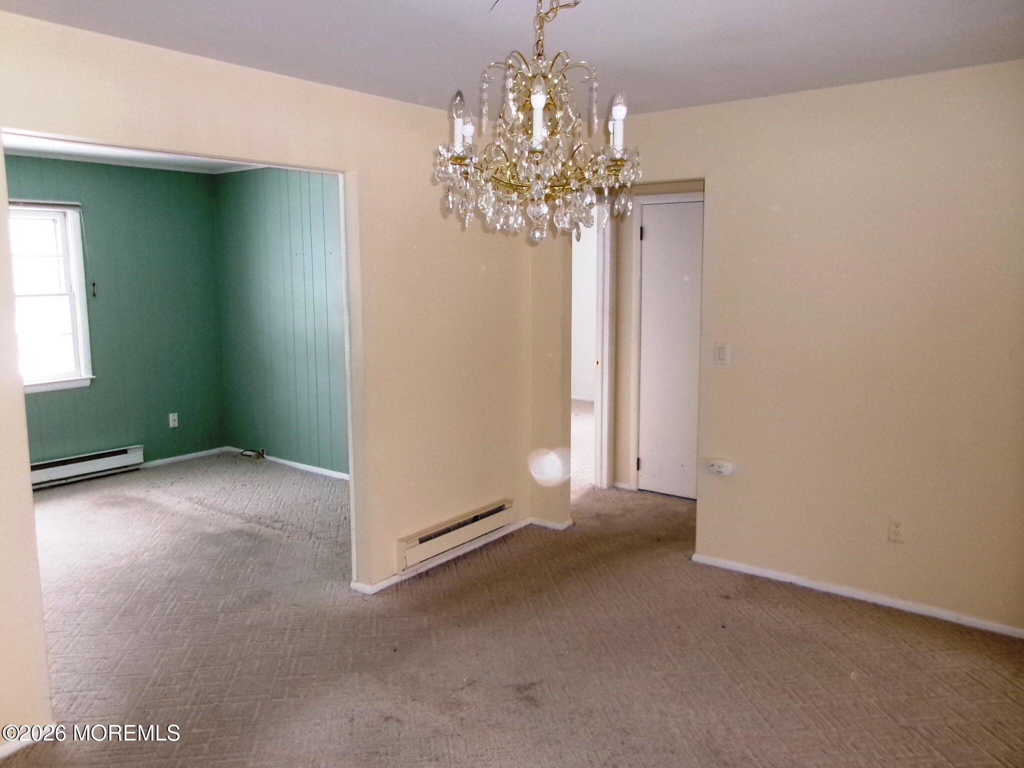 63 Eton Road Toms River, NJ 08757 - Photo 11 of 23 a view of a chandelier in big room and windows