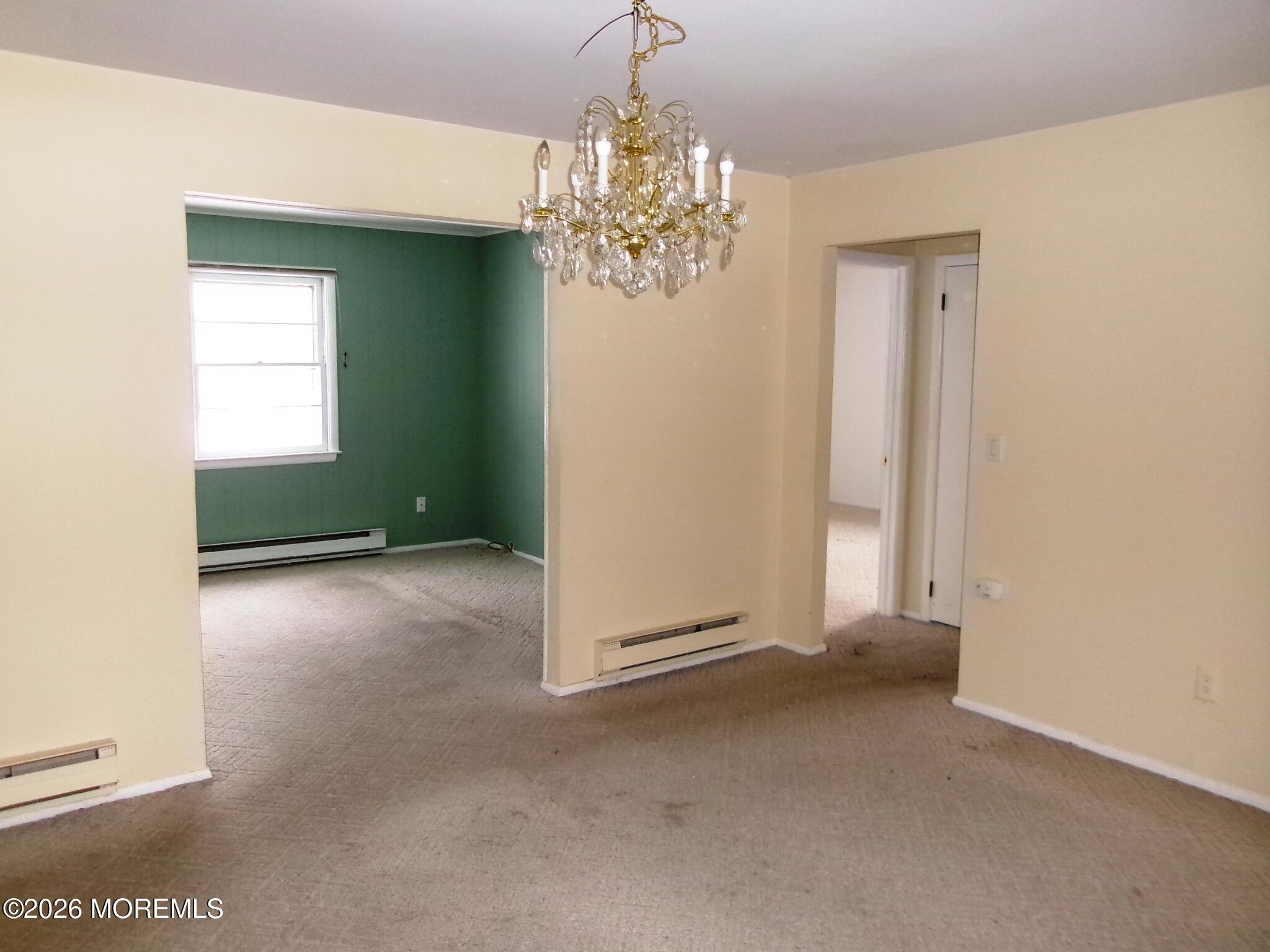63 Eton Road Toms River, NJ 08757 - Photo 20 of 23 an empty room with windows and chandelier