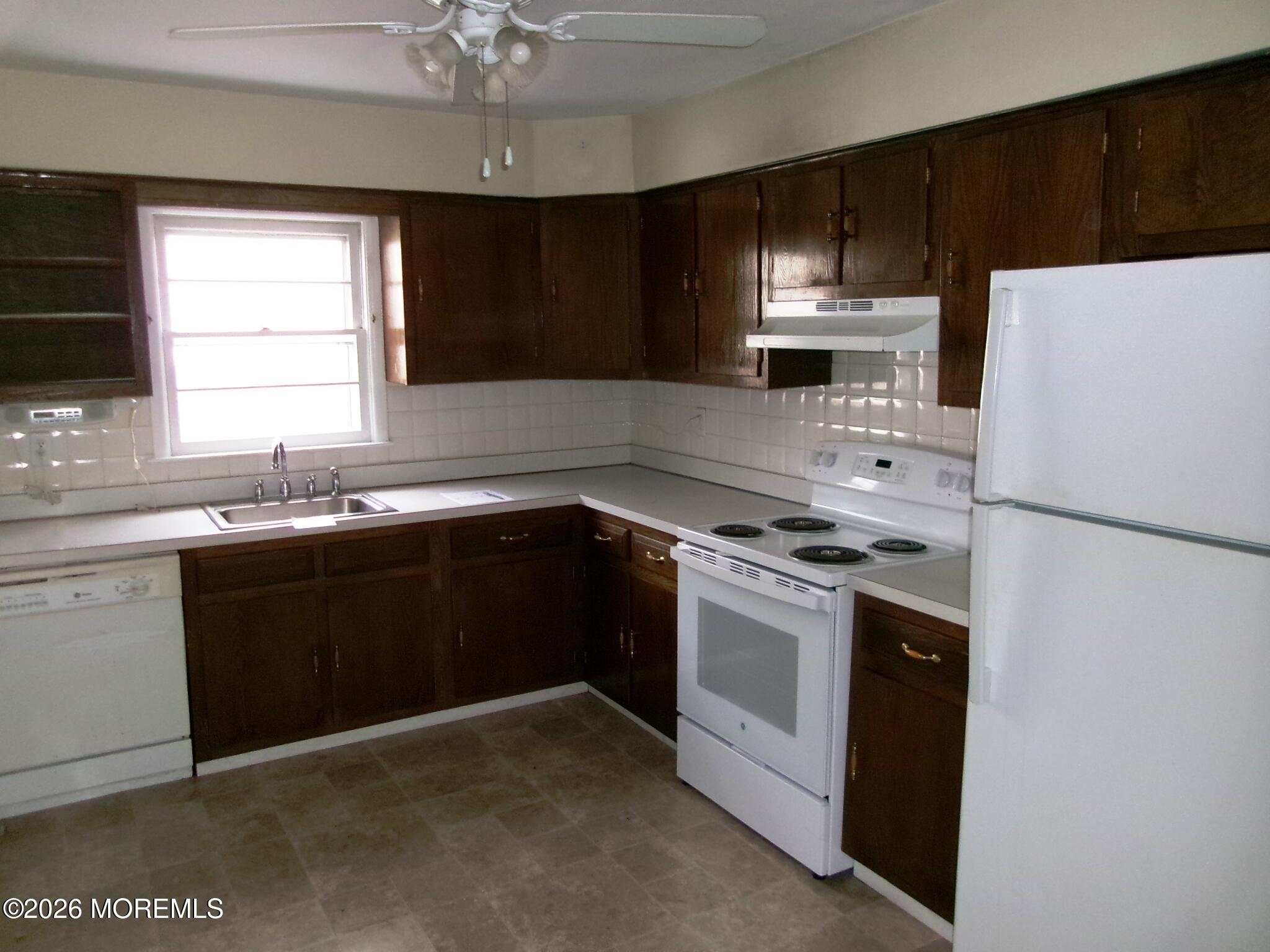 63 Eton Road Toms River, NJ 08757 - Photo 5 of 23 a kitchen with a sink a stove a refrigerator and cabinets