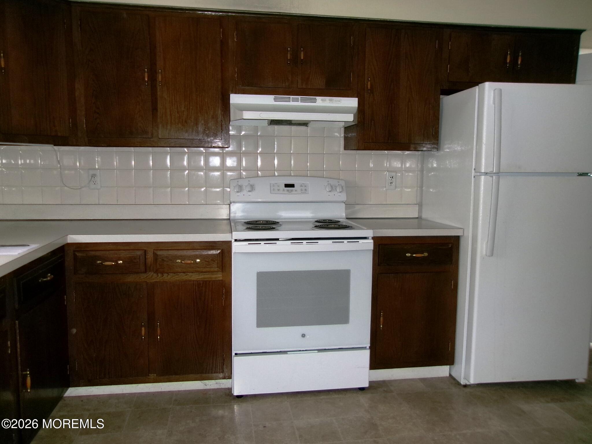 63 Eton Road Toms River, NJ 08757 - Photo 6 of 23 a kitchen with a stove and a refrigerator