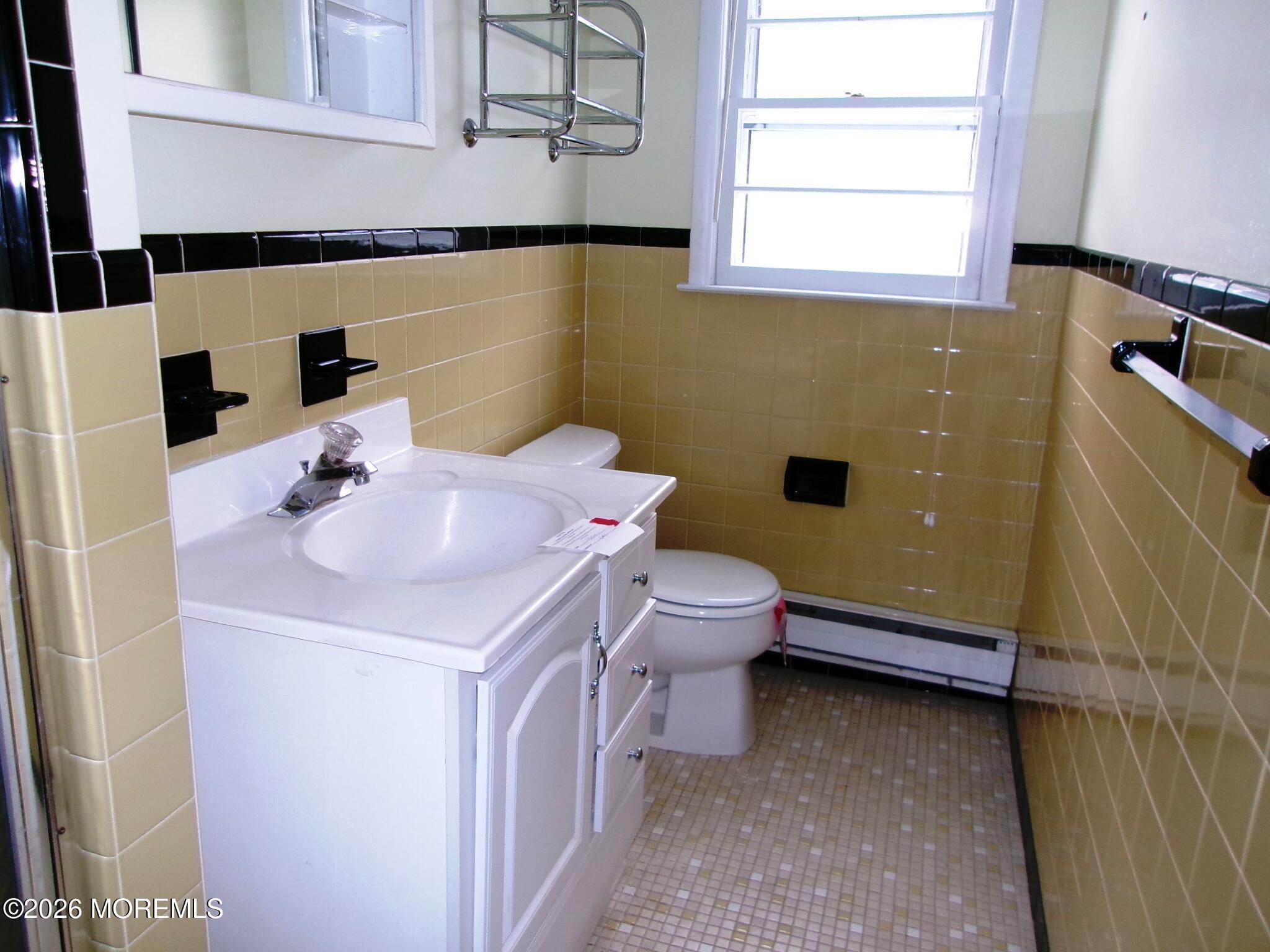 63 Eton Road Toms River, NJ 08757 - Photo 7 of 23 a bathroom with a sink a toilet and a mirror