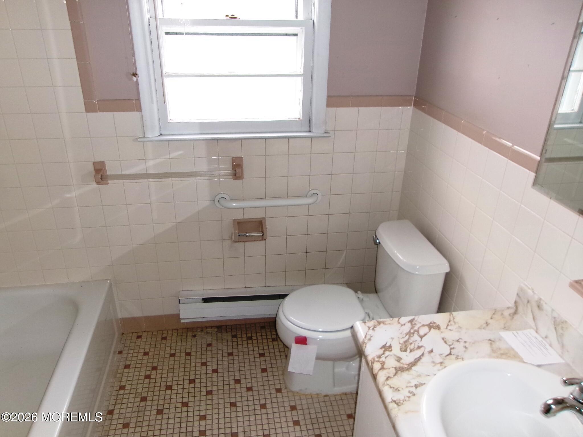 63 Eton Road Toms River, NJ 08757 - Photo 8 of 23 a bathroom with a toilet and a shower curtain