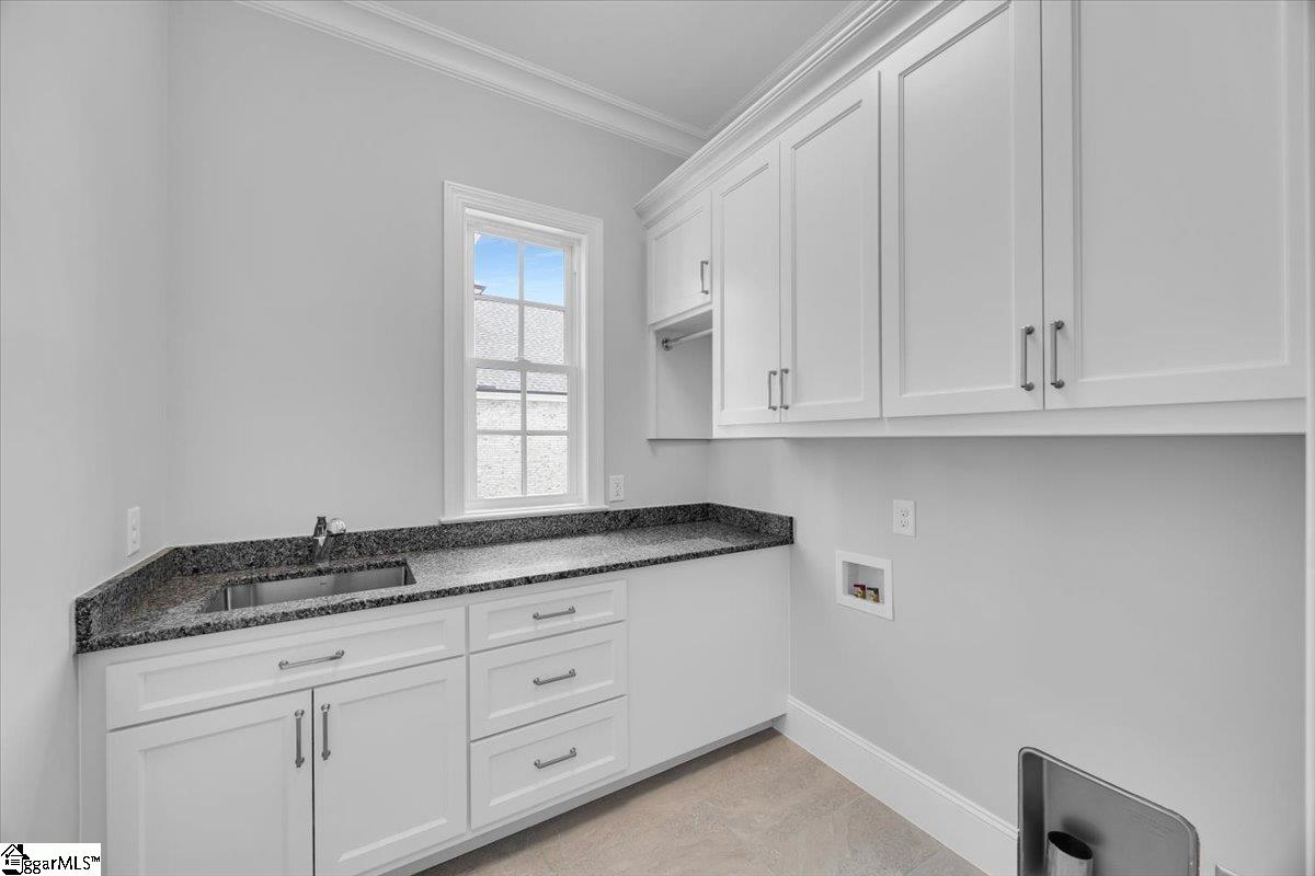 202 Chestnut Pond Lane Simpsonville, SC 29681 - Photo 24 of 50 Large Laundry just off garage entrance is the perfect location for dropping dirty items and washing up. With sink and granite countertops.