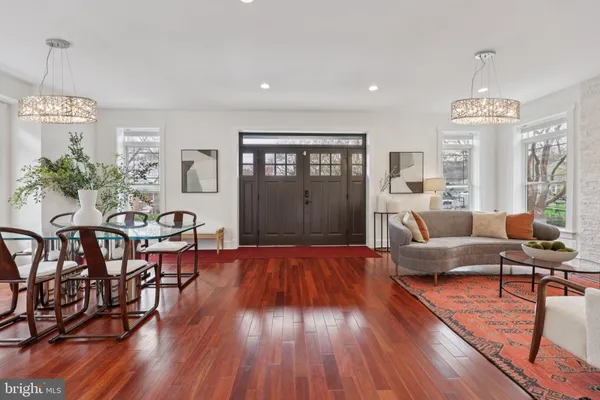 a living room with furniture dining table and a large window