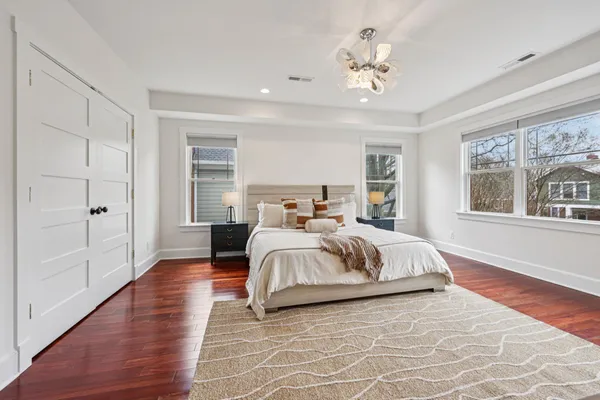 a bedroom with a bed and wooden floor