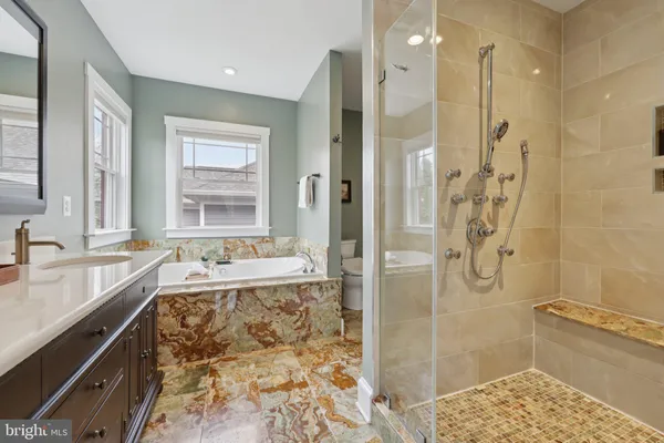 a spacious bedroom with a bed and a couch