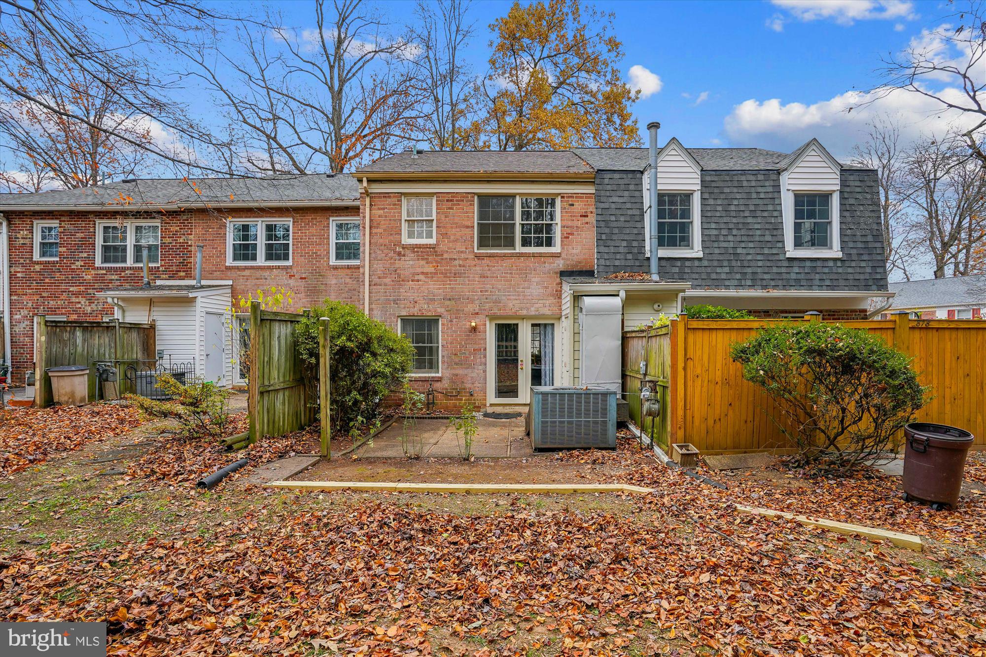 880 Azalea Drive, Unit 22880 Rockville, MD 20850 - Photo 19 of 39 a view of a brick house with many windows next to a yard