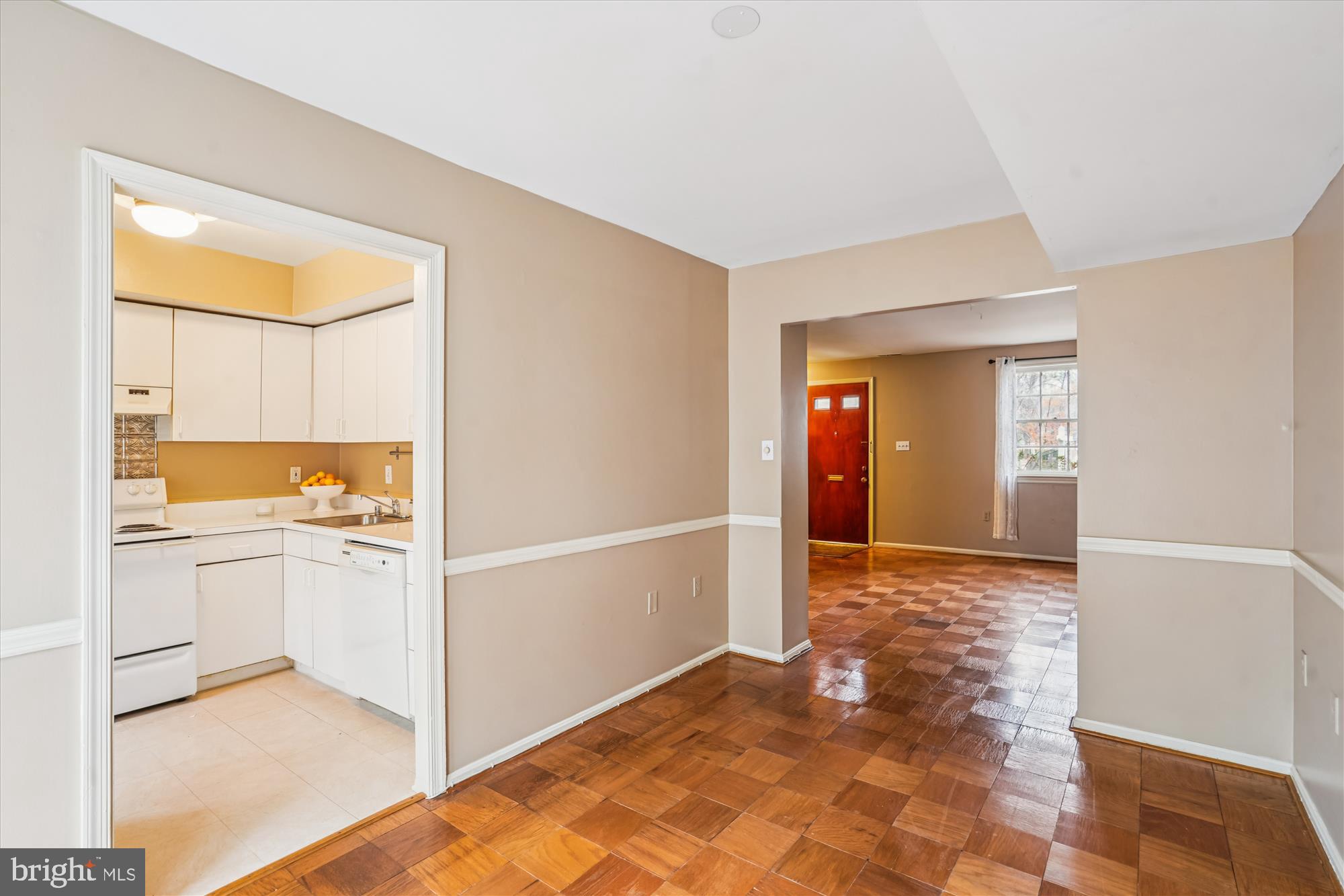 880 Azalea Drive, Unit 22880 Rockville, MD 20850 - Photo 7 of 39 a view of a hallway to an empty room with wooden floor and a kitchen
