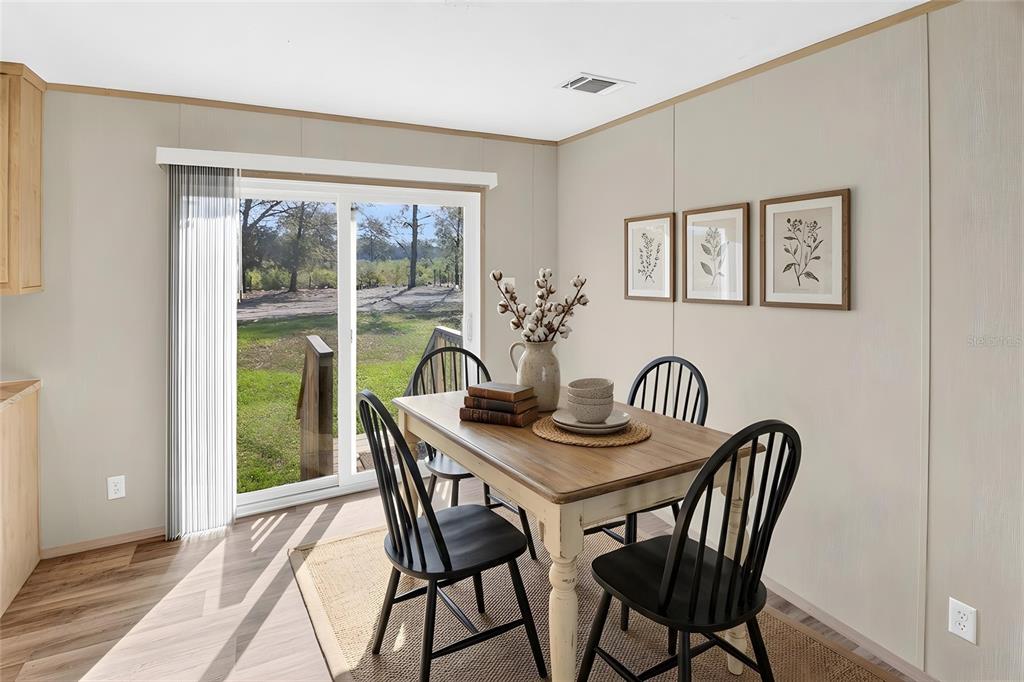 5570 Northeast 76th Avenue High Springs, FL 32643 - Photo 11 of 31 a view of a dining room with furniture window and wooden floor