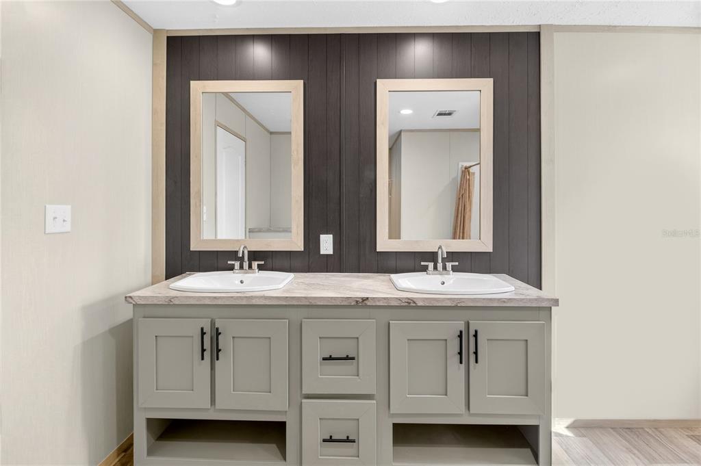 5570 Northeast 76th Avenue High Springs, FL 32643 - Photo 14 of 31 a bathroom with a double vanity sink and mirror