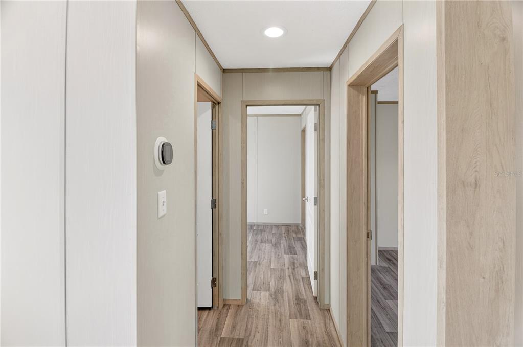 5570 Northeast 76th Avenue High Springs, FL 32643 - Photo 18 of 31 a view of a hallway with wooden floor