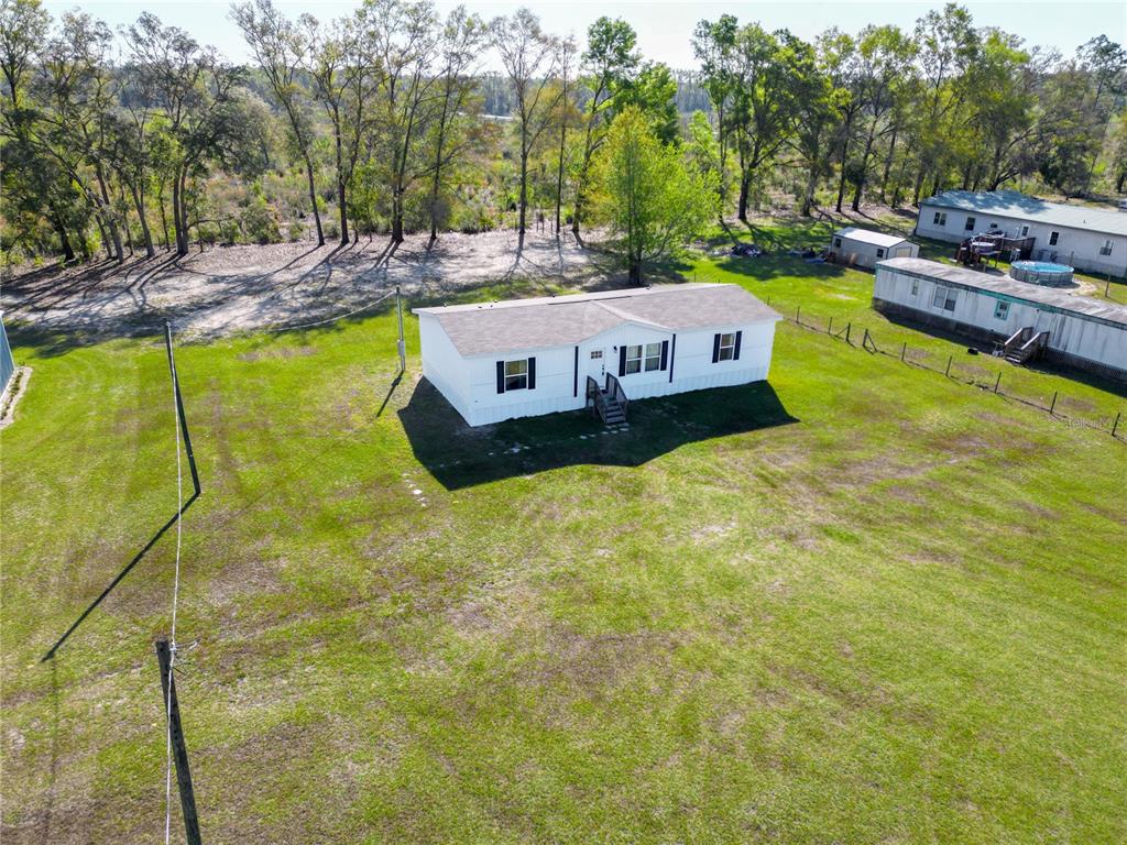 5570 Northeast 76th Avenue High Springs, FL 32643 - Photo 24 of 31 a view of a swimming pool with a patio and yard of the house