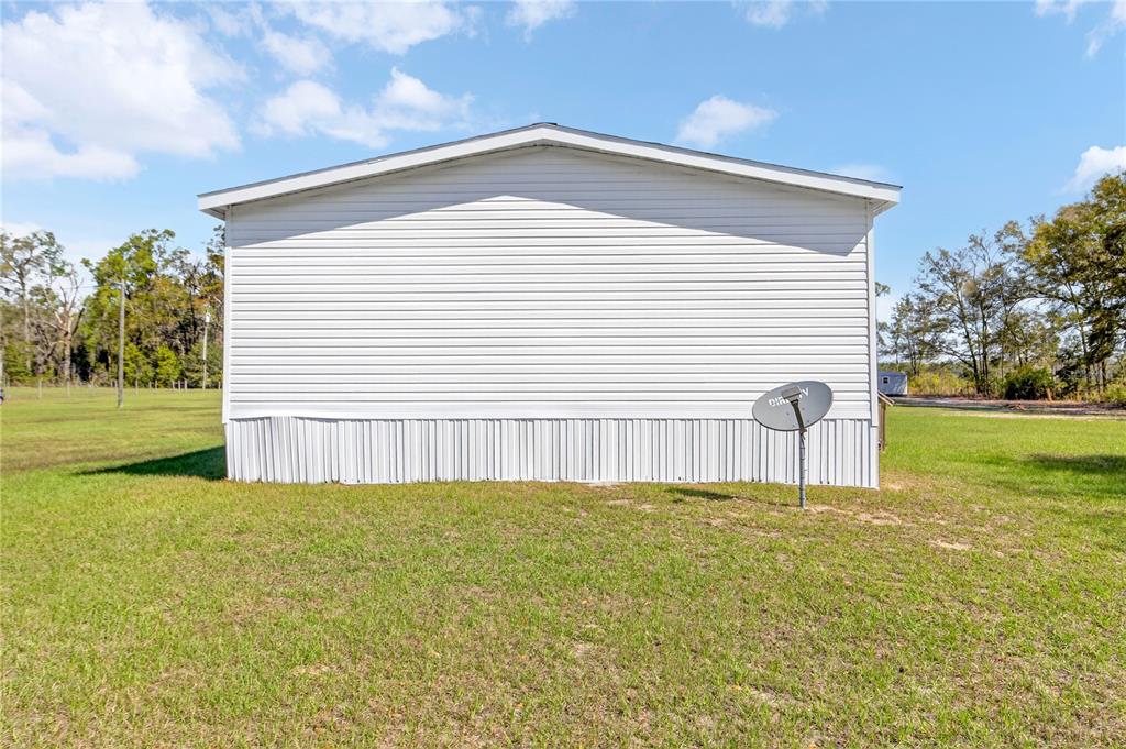5570 Northeast 76th Avenue High Springs, FL 32643 - Photo 27 of 31 a front view of a house with a yard
