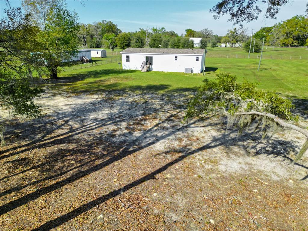 5570 Northeast 76th Avenue High Springs, FL 32643 - Photo 29 of 31 a view of a big yard with wooden fence