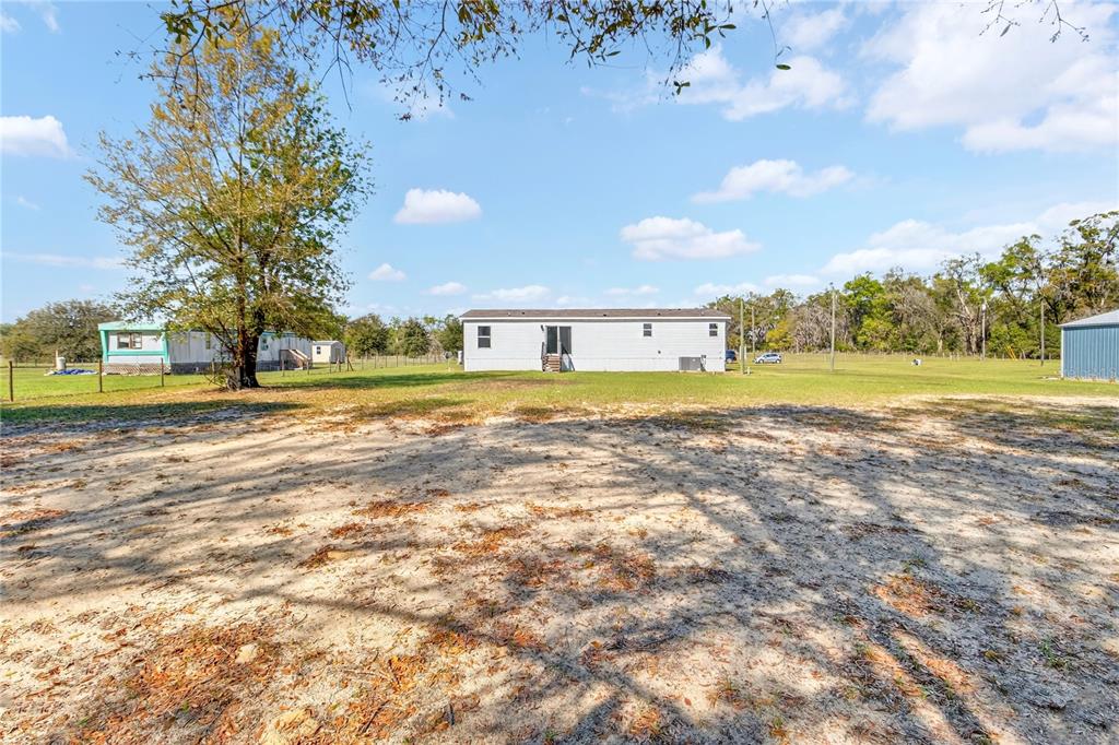 5570 Northeast 76th Avenue High Springs, FL 32643 - Photo 31 of 31 a view of a swimming pool and a yard