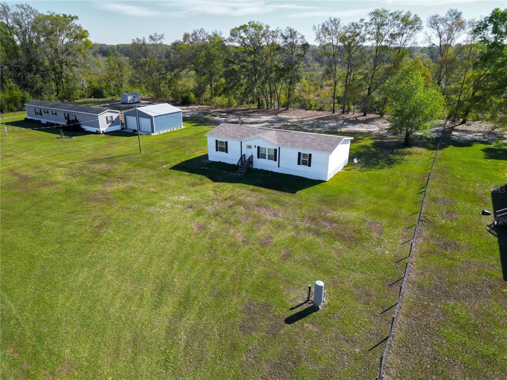 5570 Northeast 76th Avenue High Springs, FL 32643 - Photo 4 of 31 a aerial view of a house with swimming pool garden and mountain view