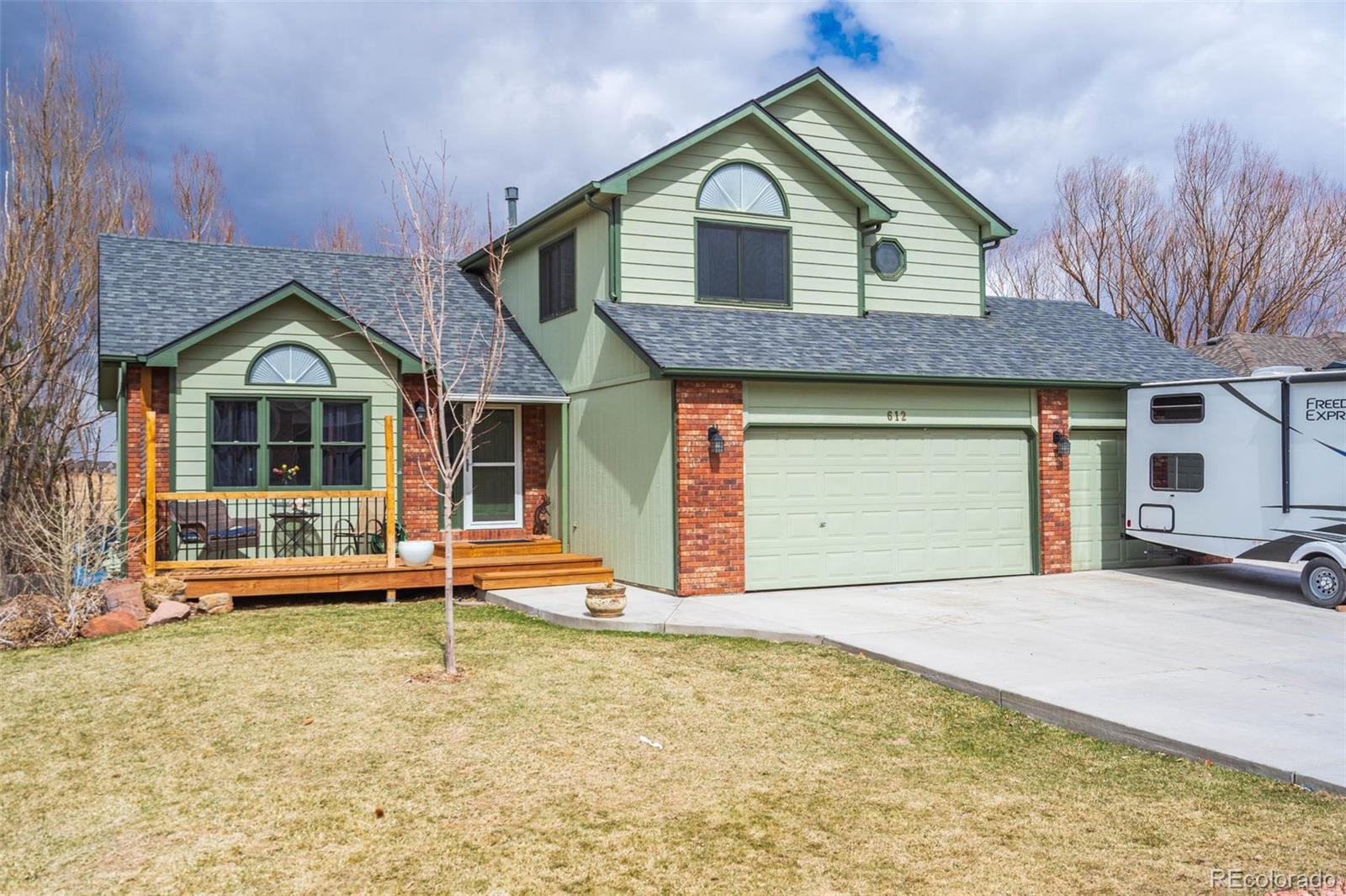 612 Ruby Drive Fort Collins, CO 80525 - Photo 1 of 40 a front view of a house with garden
