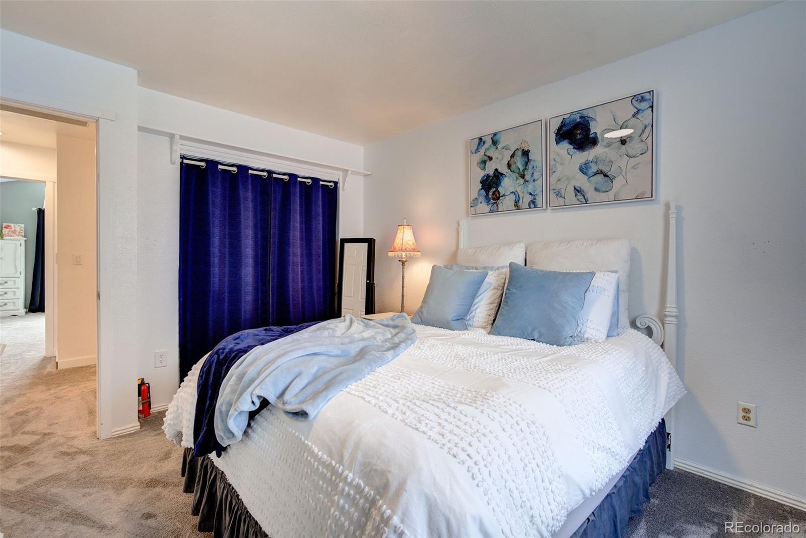 612 Ruby Drive Fort Collins, CO 80525 - Photo 20 of 40 a bedroom with bed and wooden floor