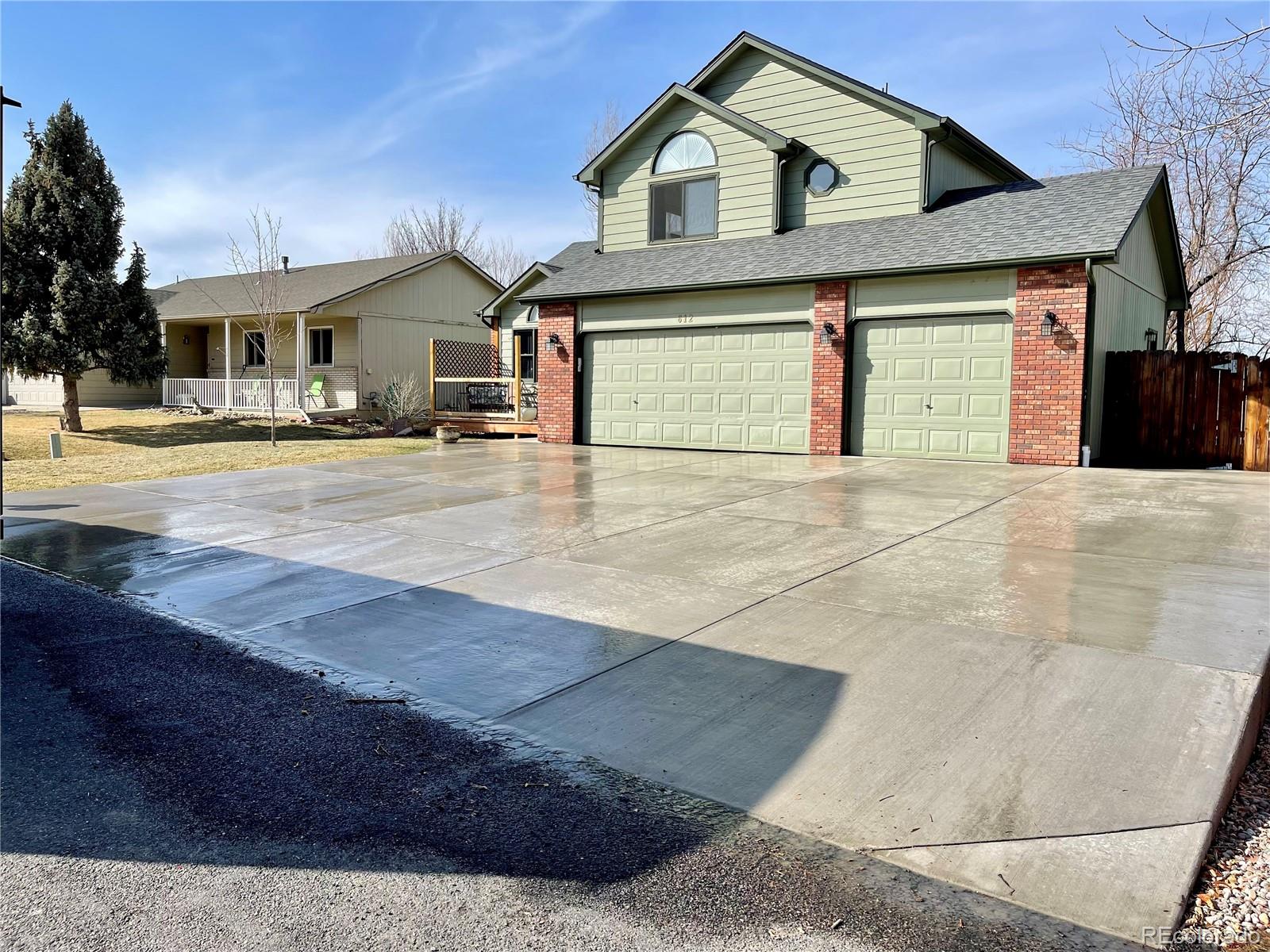 612 Ruby Drive Fort Collins, CO 80525 - Photo 2 of 40 a front view of a house with a yard and garage