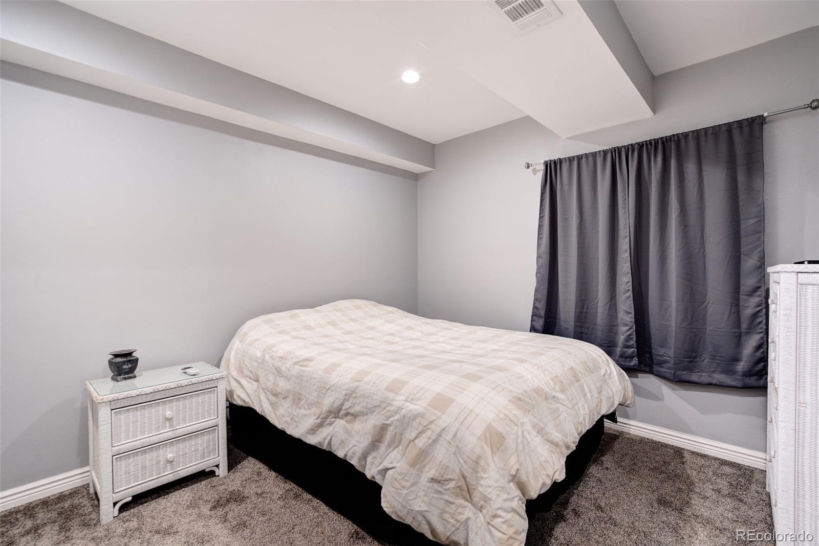 612 Ruby Drive Fort Collins, CO 80525 - Photo 24 of 40 a bedroom with a bed and a window