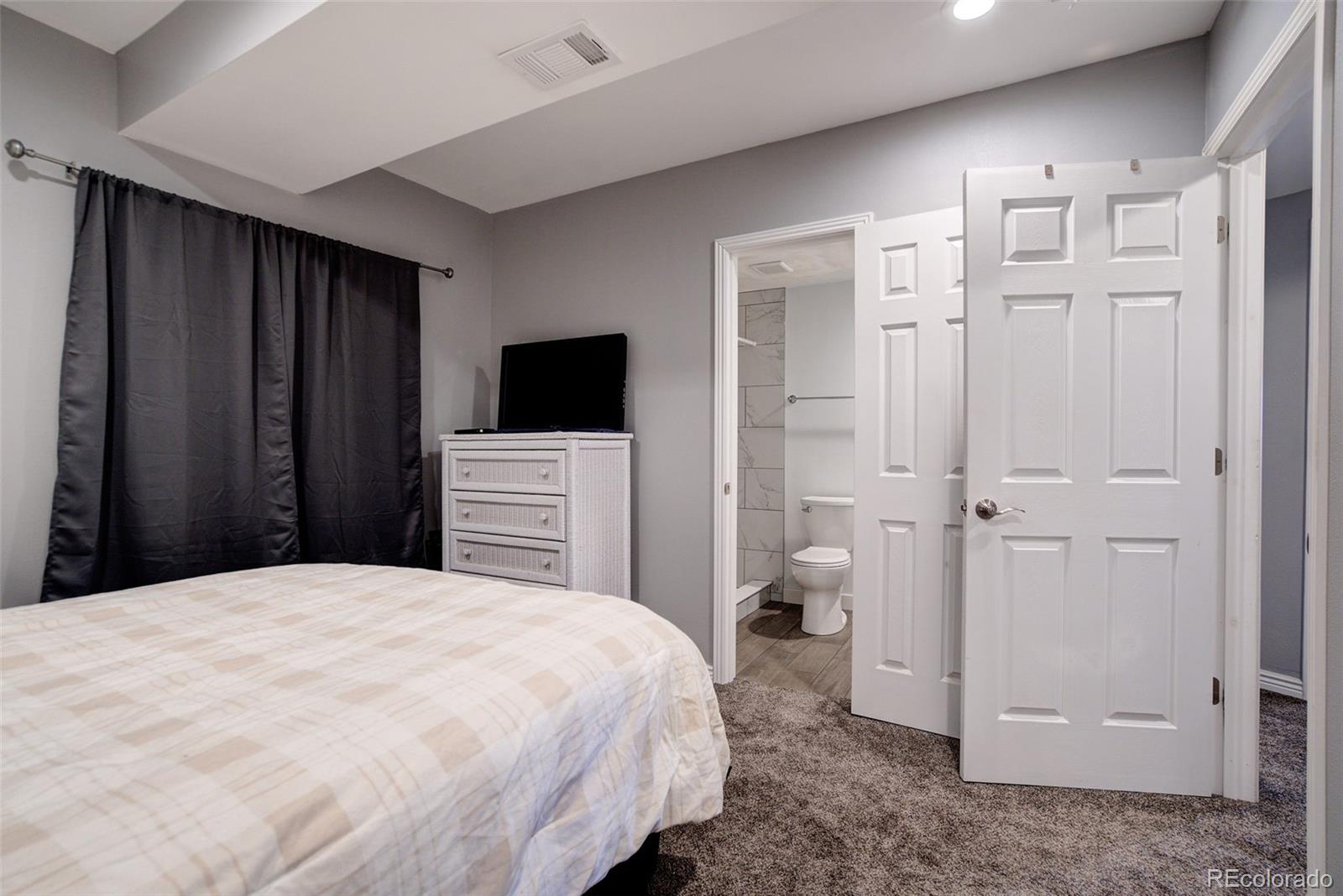 612 Ruby Drive Fort Collins, CO 80525 - Photo 25 of 40 a bedroom with a bed and a view