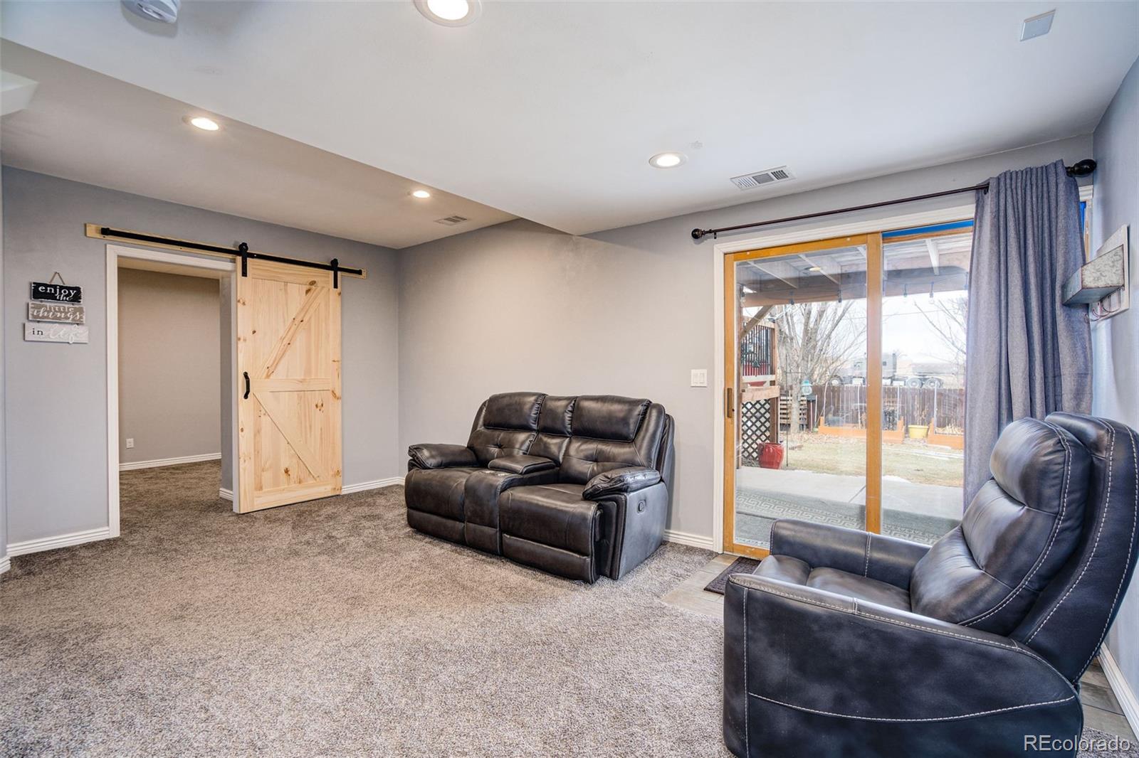 612 Ruby Drive Fort Collins, CO 80525 - Photo 30 of 40 a living room with furniture and a large window