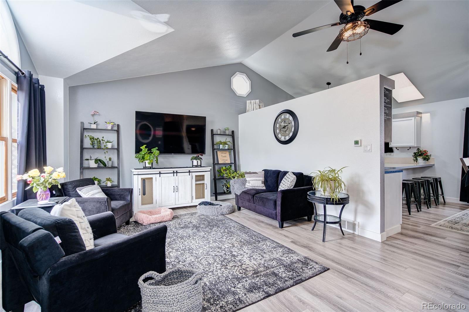 612 Ruby Drive Fort Collins, CO 80525 - Photo 3 of 40 a living room with furniture and a flat screen tv