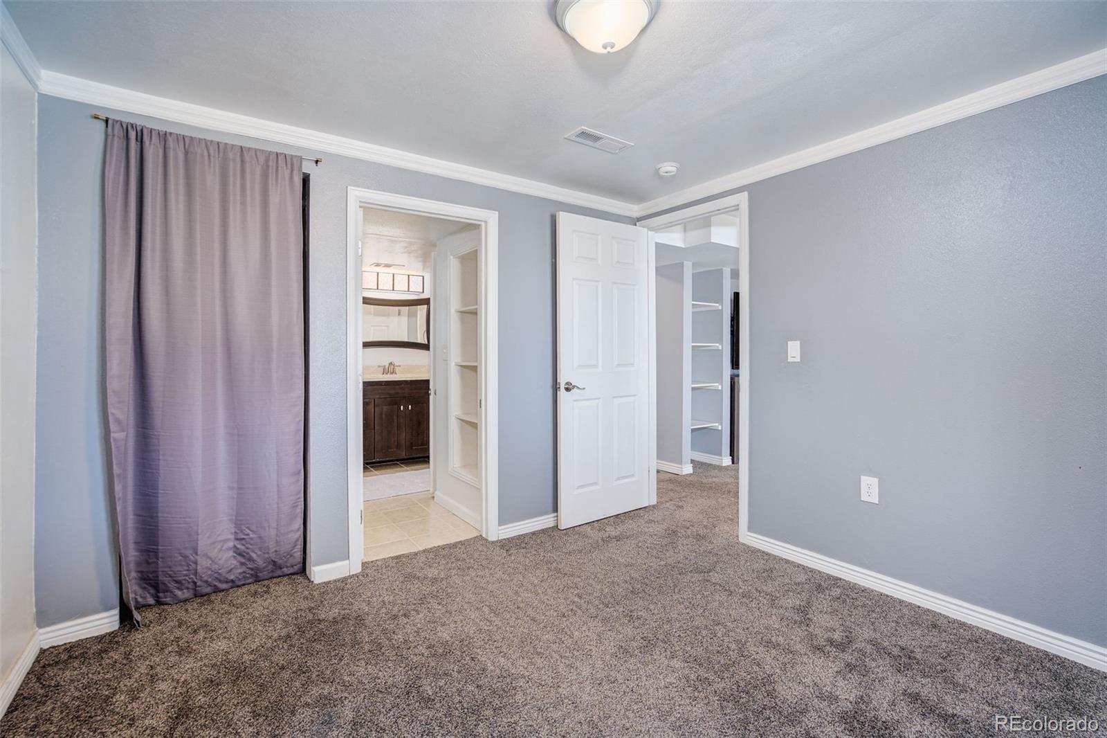 612 Ruby Drive Fort Collins, CO 80525 - Photo 32 of 40 an empty room with closet and a chandelier fan