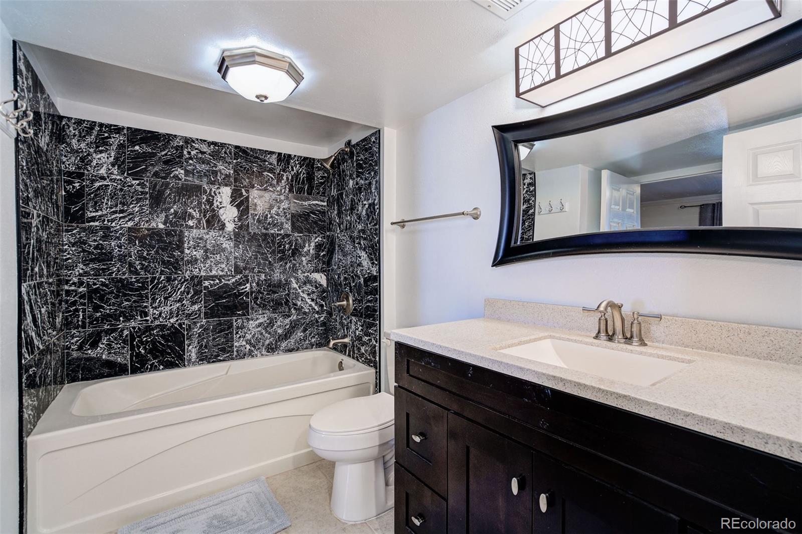 612 Ruby Drive Fort Collins, CO 80525 - Photo 33 of 40 a bathroom with a sink a toilet and shower