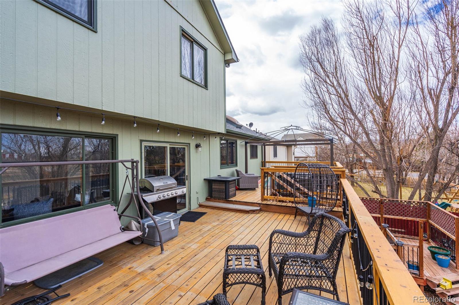 612 Ruby Drive Fort Collins, CO 80525 - Photo 34 of 40 a view of a patio with couches table and chairs and potted plants