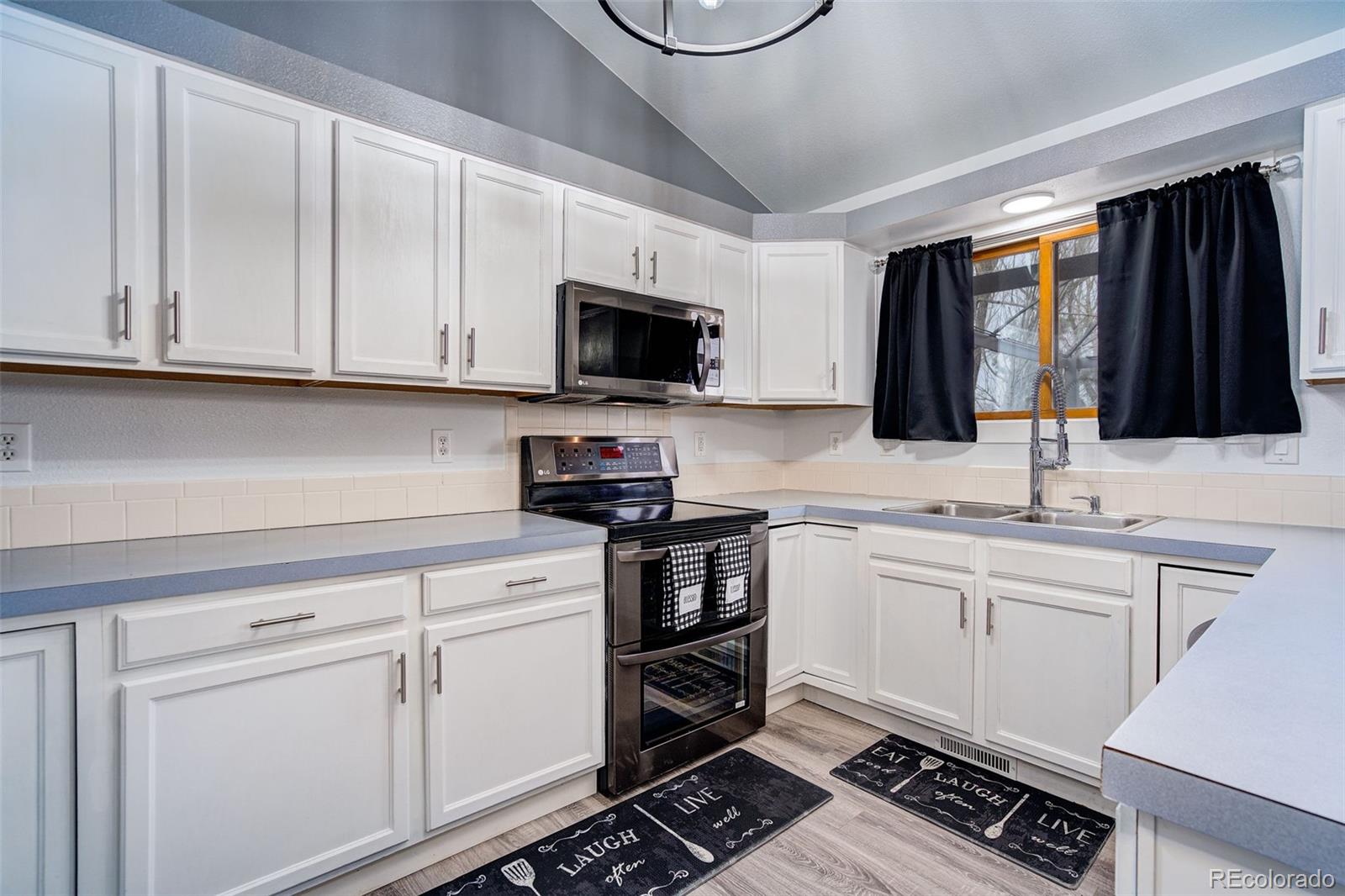 612 Ruby Drive Fort Collins, CO 80525 - Photo 8 of 40 a kitchen with stainless steel appliances a sink stove and cabinets