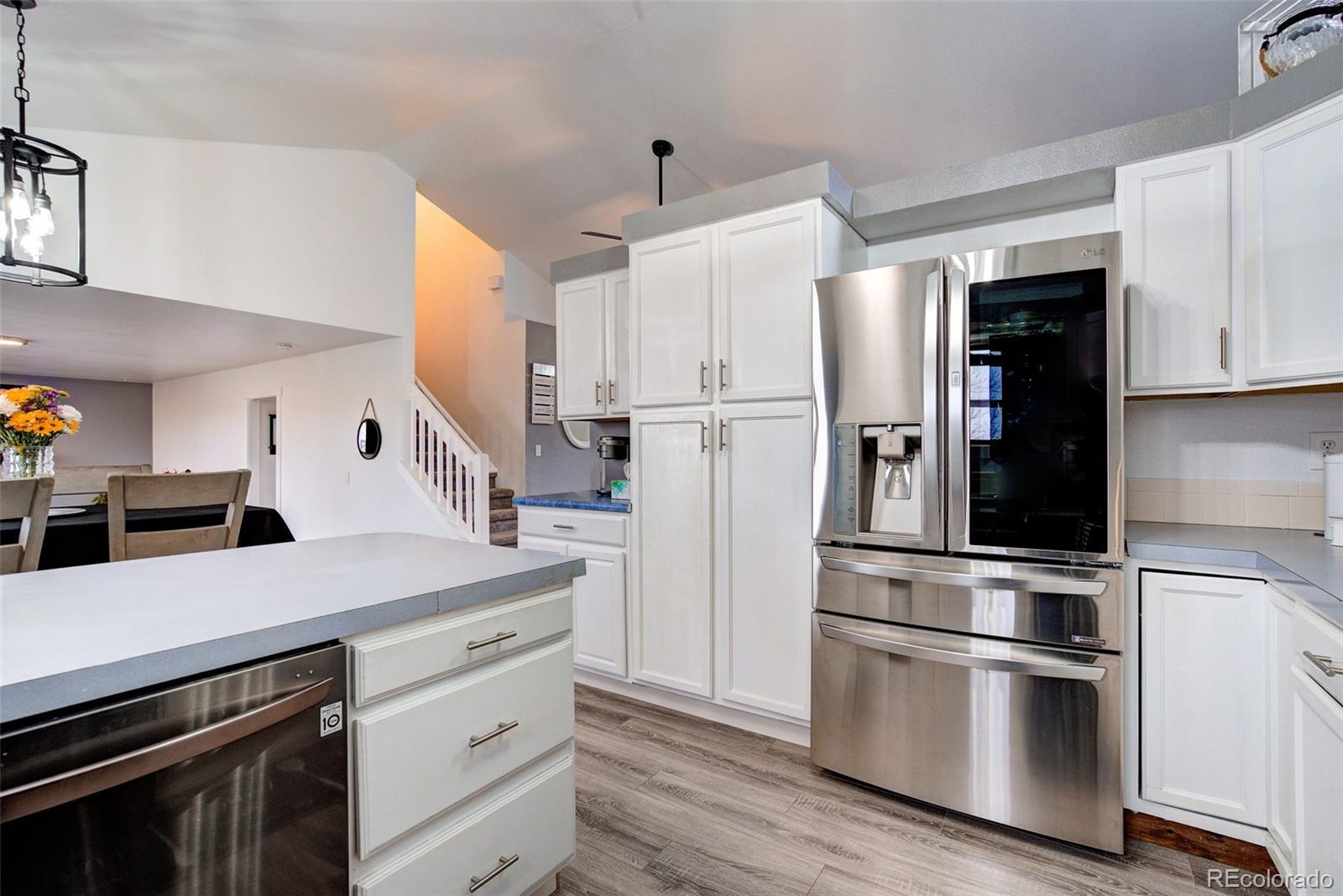 612 Ruby Drive Fort Collins, CO 80525 - Photo 9 of 40 a kitchen with stainless steel appliances and white cabinets