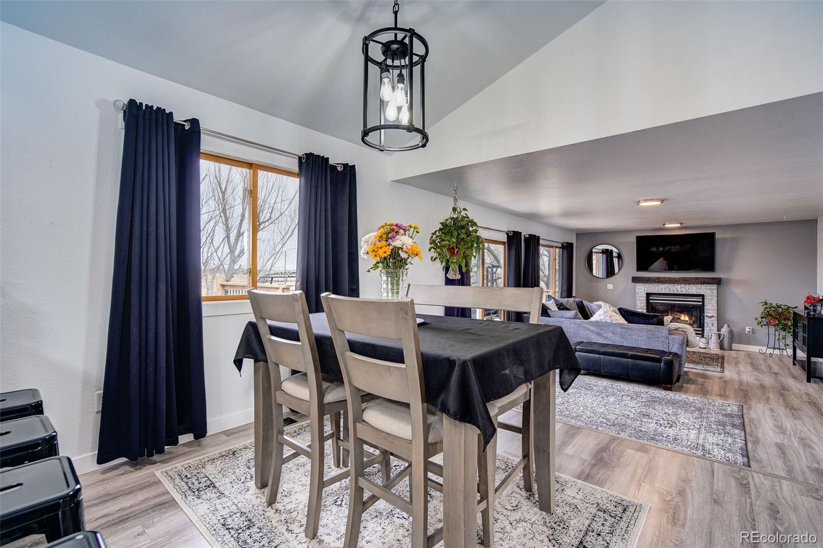 612 Ruby Drive Fort Collins, CO 80525 - Photo 10 of 40 a view of a dining room with furniture window and wooden floor