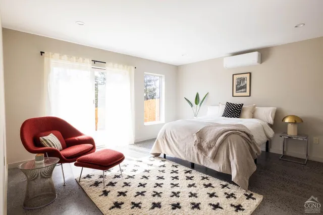 a bedroom with a bed and chair