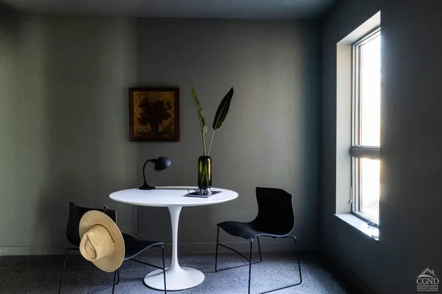 a view of a dining room with furniture and window