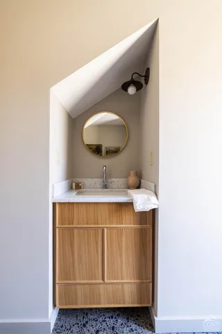 a bathroom with a sink and mirror
