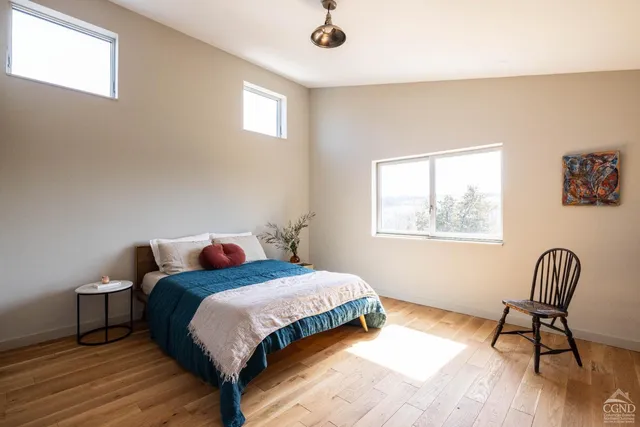 a bedroom with a bed chair and window