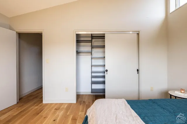 a bedroom with a bed and a hallway