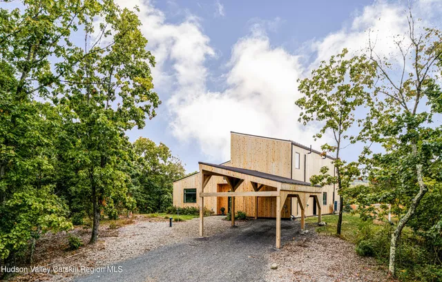 an aerial view of residential houses with outdoor space and trees