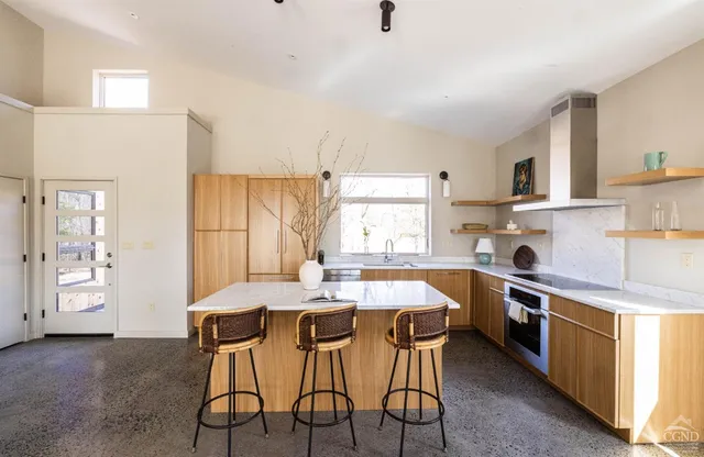 a kitchen that has a table and chairs in it