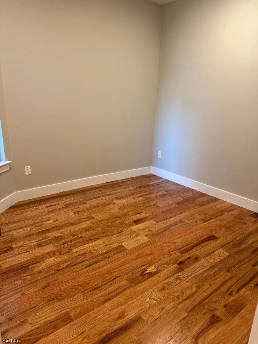 76 Barbara Street, Unit 1 Newark, NJ 07105 - Photo 6 of 8 a view of an empty room with wooden floor