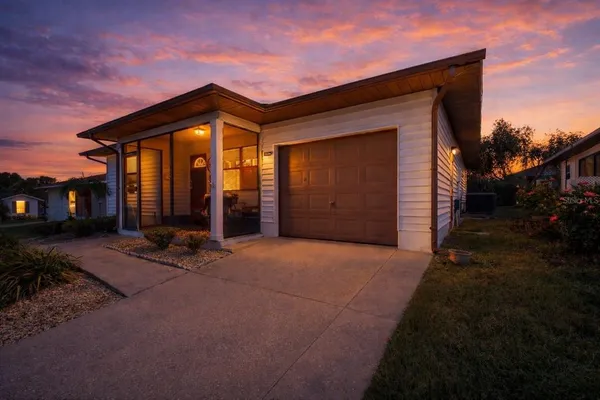 a view of a house with backyard and porch
