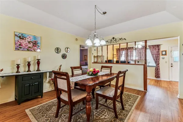 a living room with stainless steel appliances furniture and a kitchen view