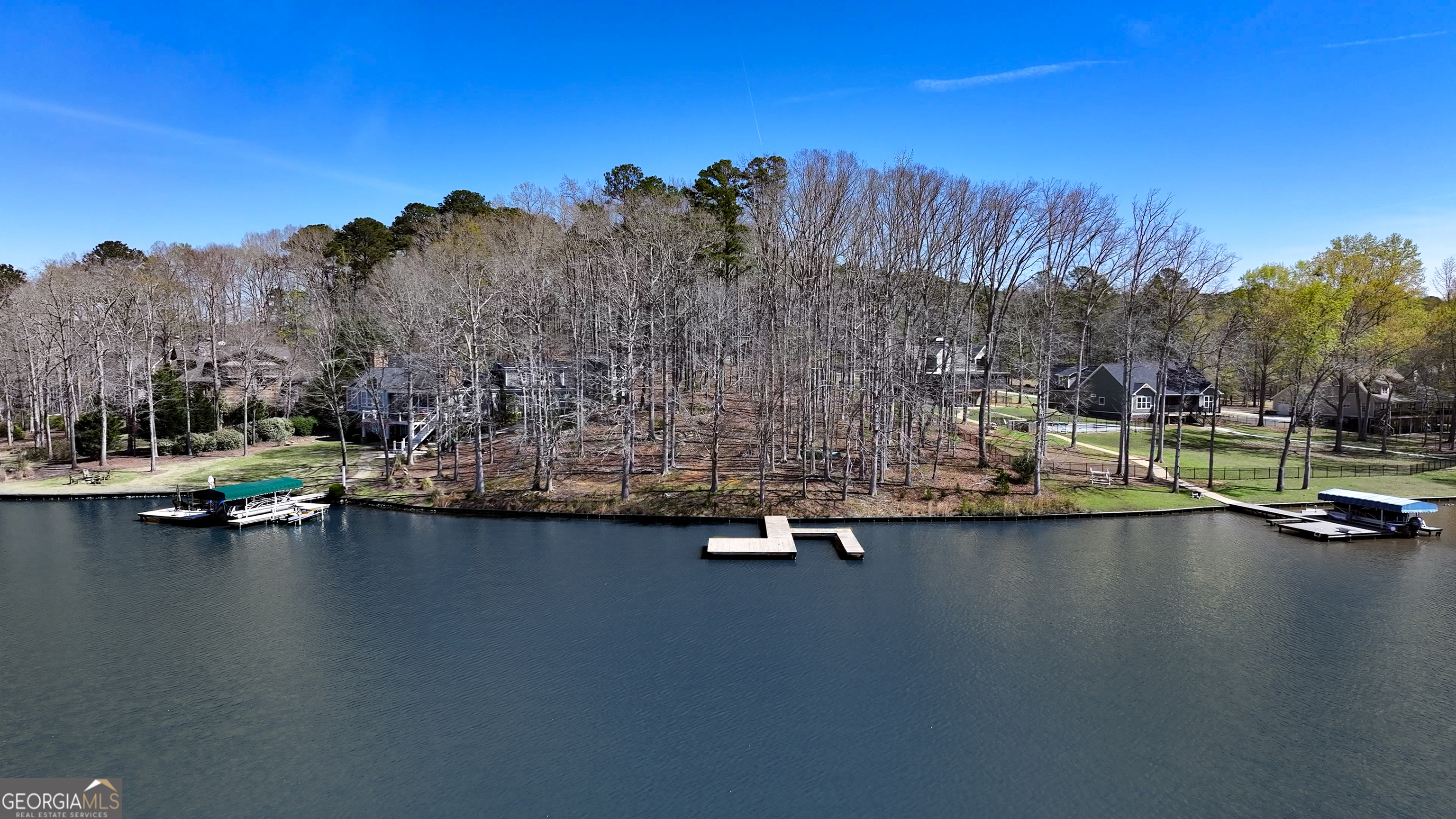 1921 Withrow Road Greensboro, GA 30642 - Photo 1 of 15 a view of swimming pool with outdoor seating and trees in the background